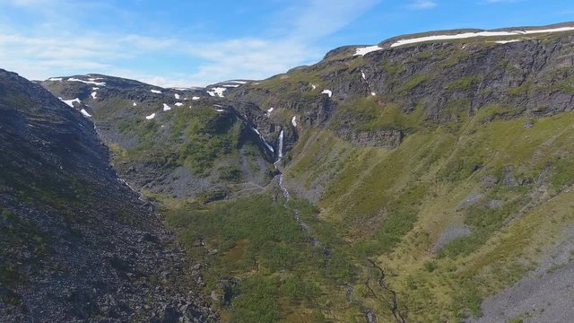 Aerial view of mountain valley and waterfall next to road to Nordkapp in Norway
