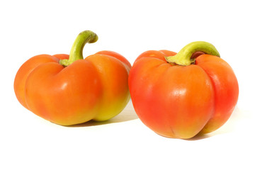 Two juicy sweet peppers on a white background