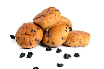 Buns with raisins on a white background with reflection.