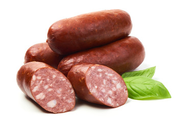 Smoked sausages with sausage slices and basil herb, isolated on white background.