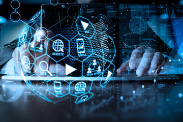 business man hand working on laptop computer with digital layer business strategy.