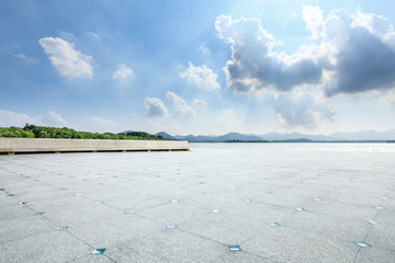 Clean square floor and mountain with lake on a sunny day