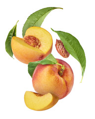 Flying fresh ripe peach with green leaves isolated