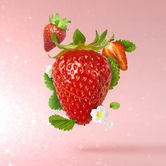 Flying Fresh tasty ripe strawberry with green leaves