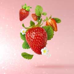 Flying Fresh tasty ripe strawberry with green leaves