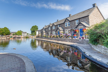 Cottages reflecting in the water of  Brecon Canal basin  in Brecon town, Brecon Beacons National Park, Wales, UK
