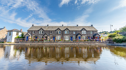 Cottages reflecting in the water of  Brecon Canal basin  in Brecon town, Brecon Beacons National Park, Wales, UK