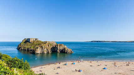 Panoroma of Saint Catherine's island and fort at the coast of Tenby on a hot summer day, Wales, UK....