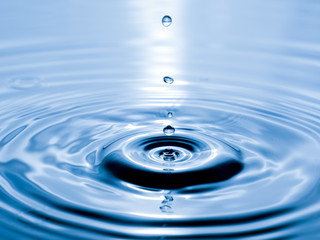 close up drop of water on blue background
