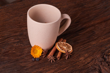 Dried fruit tea for healthy breakfast. cup of cream color and flower on wooden table. Concept of health food