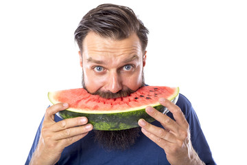 Bearded man eating watermelon