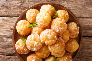 French dessert chouquette profiteroles with pearly sugar and mint closeup. Horizontal top view