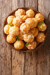 Chouquettes French Cream Puffs dessert is decorated with pearl sugar and mint closeup. Vertical top view