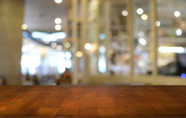 Empty dark wooden table in front of abstract blurred bokeh background of restaurant . can be used for display or montage your products.Mock up for space.
