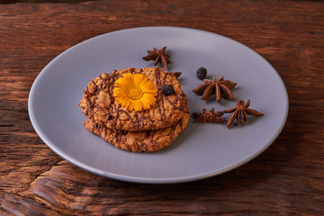cookies and spring orange flowers on plate. Healthy morning breakfast concept. Minimalist. selective focus