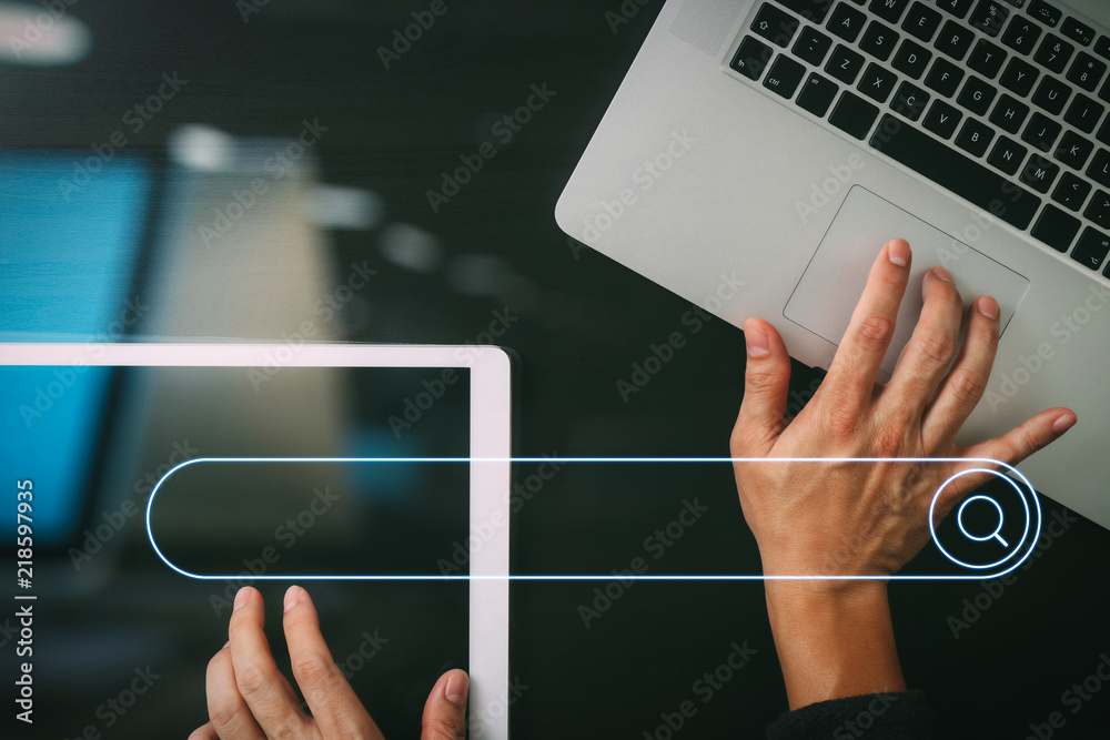 Leinwandbilder cyber security internet and networking concept.Businessman hand working with  laptop computer and digital tablet background
