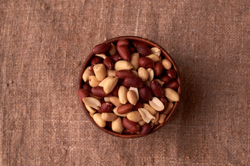 dry peanuts background. close up dry peanuts in clay bowl. Space for pext. Copyspace