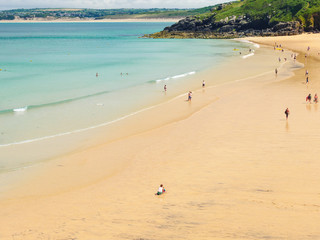 Families enjoying Porthminster Beach, in St Ives, on a hot Summer day.