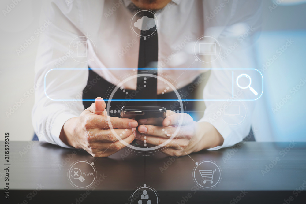Poster close up of businessman working with smart phone on wooden desk in modern office with virtual icon d