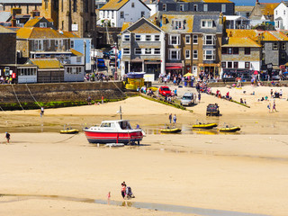 St Ives seafront and beach full of visitors on a hot Summer day.