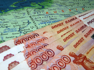 Russian rubles on the map of Russia. Concept of the Russian economy