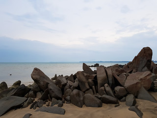 Sand beach, with rocks in foreground.