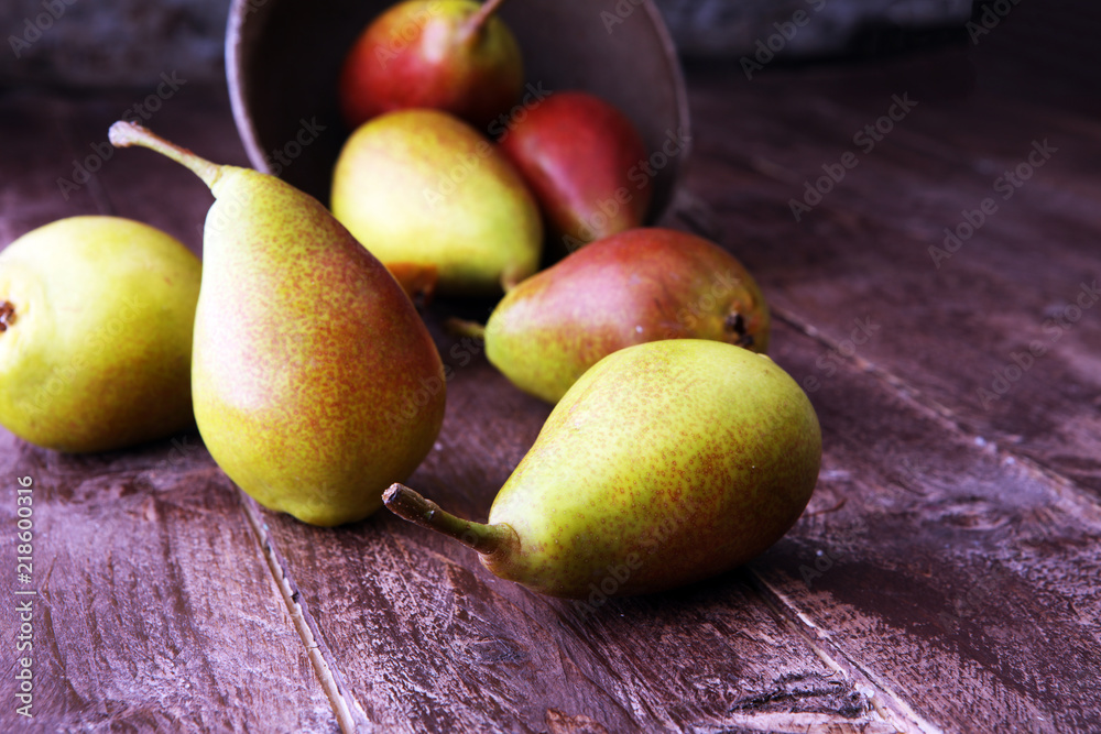 Wall mural fresh ripe organic pears on rustic wooden table, natural background, vega, diet food.