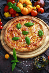 Stone Baked Pizza margherita with farm tomatoes sauce, parmesan and mozzarella cheese, basil
