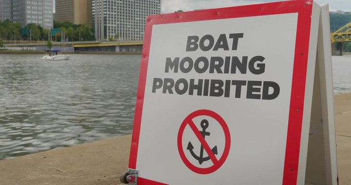 A boat mooring prohibited warning sign on the shore of the Allegheny River in downtown Pittsburgh, Pennsylvania.  	