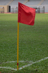 Red flag pole at corner kick marking of soccer field