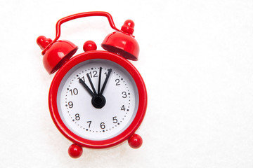 Red alarm clock on the white background