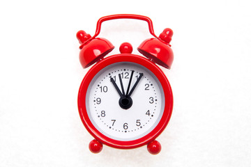 Red alarm clock on the white background