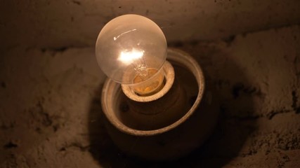 Light bulb in basement in 4k slow motion - Powered by Adobe