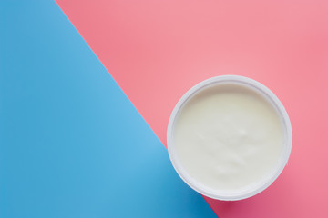 Set yogurt with natural flavour on pink and blue pastel color background for healthy eating concept. Flat lay and top view image.