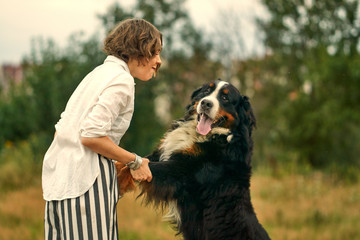 a girl and a large dog dog stands on its hind legs.