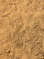 Many footprint on the sand beach texture background.