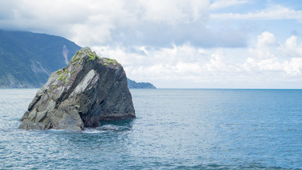 Fototapeta na wymiar The huge rock in the sea
