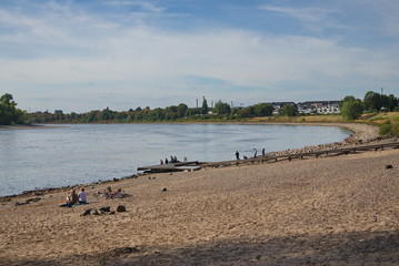 Scenery of beach and riverside on sunny day. People enjoy natural landscape at the beach around riverside of Rhine river in Düsseldorf, Germany during sun shine day. 
