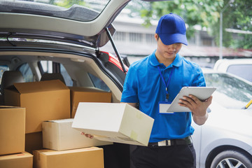 Delivery man checking list on tablet.