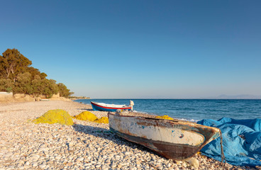 Fototapeta premium Old fishing boats on a beach of the Mediterranean Sea.