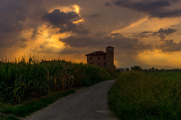 farmhouse in the countryside at sunset