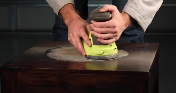 Sanding a wooden table