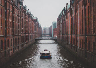 Sightseeing boat on the water of canal in hafen city in Hamburg, Germany