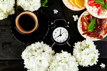 Alarm clock have a good day with a cup of coffee.