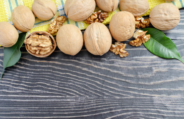 Walnut and green leaves on a dark background place for advertising