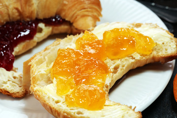 croissants with marmalade and assortment of jams, seasonal berries, apricot, mint and fruits