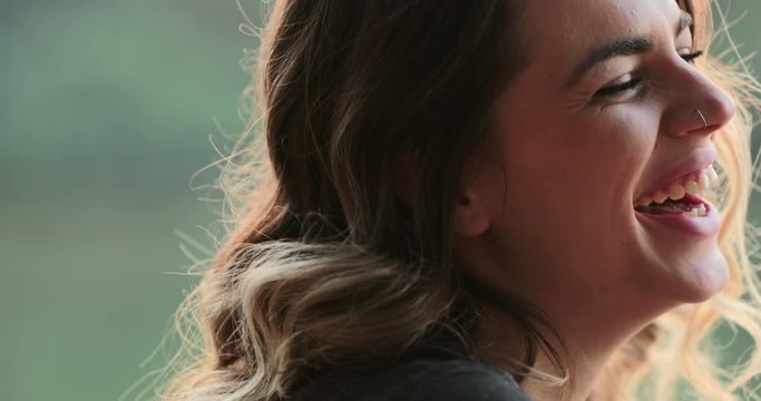 Young woman spontaneous real life laugh. Authentic candid girl acting bashful and flirtatious