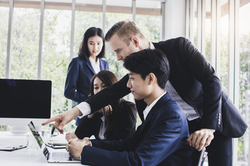 Manager or boss looking at work and admire by showing thumb for good job and successful working in...