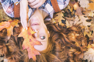 red hair beauty in orange landscape autumn