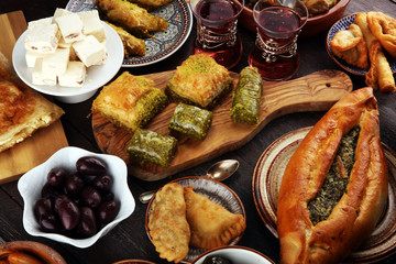 Middle eastern or arabic dishes and assorted meze, concrete rustic background. sambusak. Turkish Dessert Baklava with pistachio. Sarma. Halal food. Lebanese